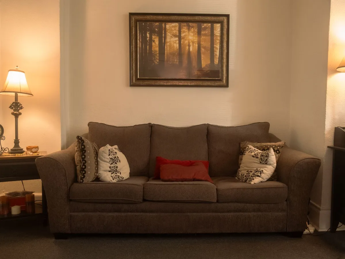 Therapy room with a couch and warm lamplight where couples meet at Coastal Therapy Group's Pasadena office